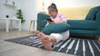 © Wosunan - On a holiday, an elderly woman relaxes with a smartphone on the sofa