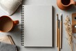 © Anik - Blank Sketchbook Surrounded by Art Supplies and Coffee