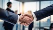 © Nicholas - business handshake close up blurred corporate office in background