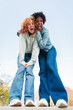© Jose Calsina - Two exuberant friends sharing a lively and enthusiastic moment filled with joy and laughter, embodying the essence of friendship and happiness in a delightful interaction that radiates energy.