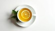 © Vadym - Top view of cup with healthy herbal tea, lemon slice and mint leaves on saucer on white background. Wellness drink in mug for breakfast to stay healthy.