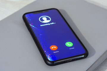 Smartphone displaying an incoming call screen with Decline and Accept buttons. Concept of communication and social networking.