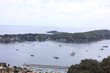 Picturesque view of city, sea and boats under beautiful sky with clouds