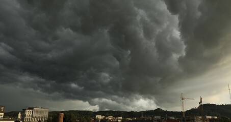 Wall Mural - beautiful sky with dark clouds over city in evening