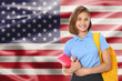 © New Africa - Happy student with backpack and notebook against flag of USA. Language school