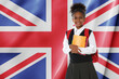 © New Africa - Little girl with backpack and notebooks against flag of United Kingdom. Language school
