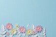 © Qianzi - Paper cut-out spring flowers in pastel pink, yellow, and white against a light blue background