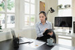 © Stella 16 - businesswoman holding digital tablet using tab application sitting at desk workplace in office. Copy space