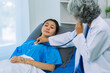 © ArLawKa - Senior female doctor holding stethoscope examining female patient checking heart rate, heart disease healthcare concept, female patient, proper care