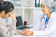 © ArLawKa - Doctor and patient discussing various matters while sitting at a table. Medical and healthcare concept. Doctor and patient.
