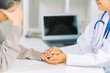 © ArLawKa - Doctor and patient discussing various matters while sitting at a table. Medical and healthcare concept. Doctor and patient.
