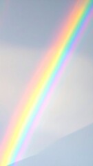 Wall Mural - A beautiful summer landscape with a vivid rainbow arcing across the blue sky and clouds after the rain