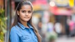 © sahina - Portrait of an Indian young girl standing outdoors in a denim shirt