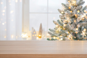 Wall Mural - Christmas presentation empty wooden table top with blurred fir tree and illumination lights background