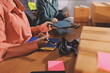 © Phanphen - Startup SME small business entrepreneur of freelance Asian woman wearing apron using laptop and box to receive and review orders online to prepare to pack sell to customers, online sme business ideas.