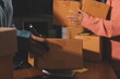 © Phanphen - Startup SME small business entrepreneur of freelance Asian woman wearing apron using laptop and box to receive and review orders online to prepare to pack sell to customers, online sme business ideas.