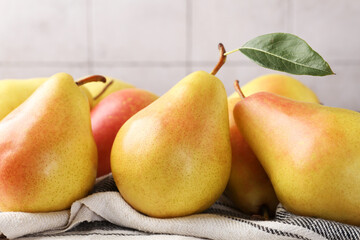 Wall Mural - Many fresh pears on table against light grey tiled wall, closeup