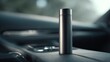© imagemir - Sleek silver thermos on a car console, blending functionality and modern design.