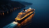 Large illuminated cruise ship sails on dark sea near rocky coast at night. Warm lights glow from ship decks. Ocean voyage creates foamy trail.