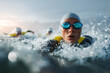 © laurent gendre - Determined swimmer powering through ocean waves during triathlon training, feeling the energy and pushing limits, competitive spirit for fitness and endurance challenge