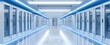 © Hasyim - A modern data center hallway is depicted with rows of server racks and bright blue accents. The perspective leads to a distant door