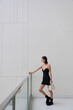 © Streetstylephoto - A female model in a black dress poses in an urban environment. Fashion shoot.