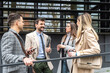 © Srdjan - IT experts freelance workers innovative technology developers, working on a new project staff meeting with casual talk in formalwear outside office building before the work. Discussing business people