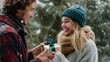© fotofabrika - Young couple sharing a joyful moment while exchanging a gift in the snowy forest