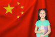 © New Africa - Little girl with notebooks against flag of China. Language school