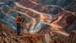 © EUT - Worker surveying at a mine uses equipment on a tripod for measurement. This represents progress, development and mining industrial businesses.