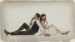 © master1305 - Young couple talking on red telephones vintage retro style. Concept of communication, romance, lifestyle branding, design, sepia effect and nostalgic advertising.