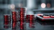 © Herman - Close-up of stacked coins in increasing heights with a calculator in blurred background