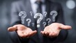 © Slamet - Close-up of a person in a business suit holding floating question marks, blurred background