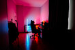 © Darius - Female gamer enjoys late-night gaming session under vibrant neon lights in a cozy room