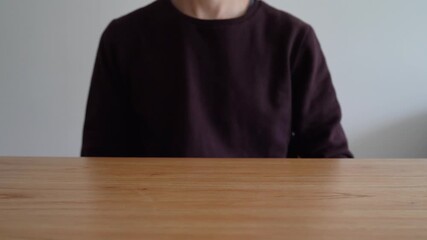 Wall Mural - Person Taps On Glowing Light Bulb Icon On Wooden Table To Make It Disappear. New Ideas And Creativity Concept. closeup shot