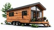 © Ghaffar stocks - A realistic tiny house on wheels with wooden siding, small windows, and modern compact design isolated on white background