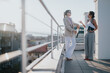 © qunica.com - Women engaged in a business discussion, standing on a rooftop under soft sunlight. Their professional conversation showcases collaboration and strategic planning in an inspiring urban environment.