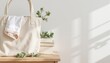 © Наталья Титова - Beige tote bag with a white cloth on a wooden table with greenery