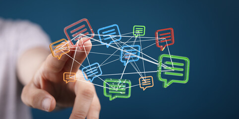 Hand touching interconnected message bubbles, symbolizing communication, digital connection, and social networking. Represents the flow of ideas