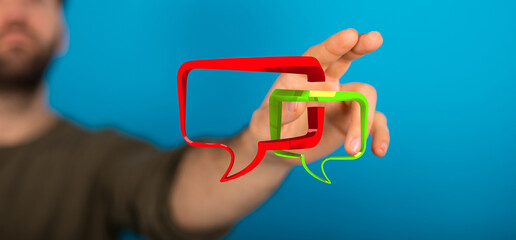a man touches virtual speech bubbles representing digital communication. this image captures the ess