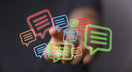 Man interacts with digital speech bubbles representing online communication and connectivity. Symbolizing modern digital technology and relation