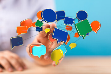 Man interacting with a network of colorful speech bubbles, representing social media, communication, and connection.