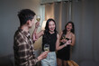 © Parichat - Young friends celebrating party with wine glasses dancing