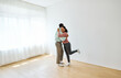© Lumos sp - Portrait of a young couple celebrating happy moving in and relocation to a new apartment, happy young couple family new beginning