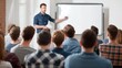 © Keo - A man in a blue shirt is standing in front of a whiteboard, giving a presentation to a group of students.