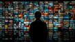 © Rifqi - Silhouette of a person standing in front of a wall filled with screens showing various content, concept for media consumption, digital overload and visual communication