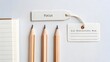 © Mohdfaridzazhar - Three sharpened pencils and tags on a white desk