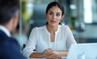 © YUTTADANAI - Professional Woman Engaged in Business Meeting at Modern Office with Laptop and Colleague