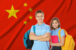 © New Africa - Students with backpacks against flag of China. Language school