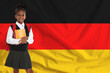© New Africa - Little girl with backpack and notebooks against flag of Germany. Language school
